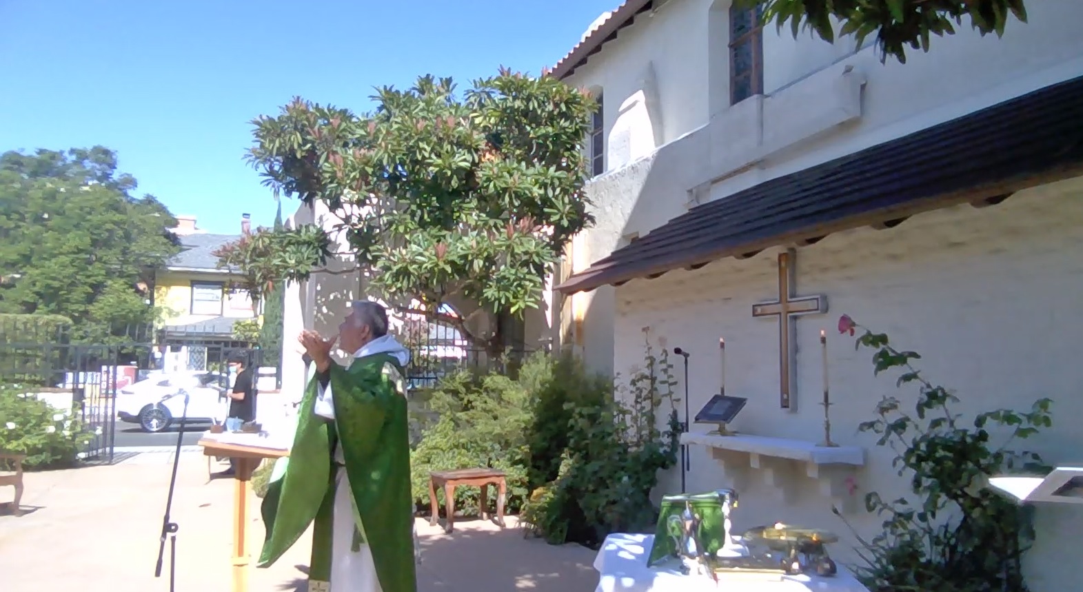 Father Carlos preaching at our courtyard Mass
